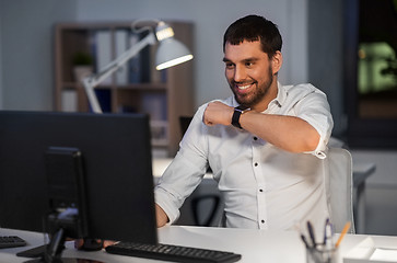 Image showing businessman using voice command on smart watch