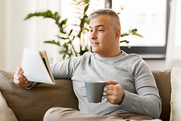 Image showing man reading newspaper and drinking coffee at home