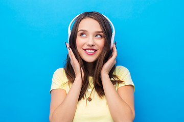 Image showing happy young woman or teenage girl with headphones