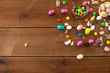 Image showing chocolate eggs and candy drops on wooden table