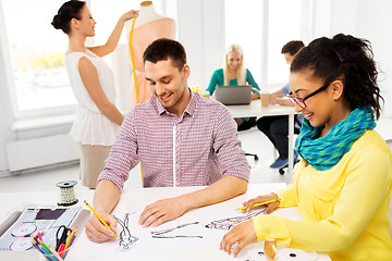 Image showing fashion designers drawing sketches at studio