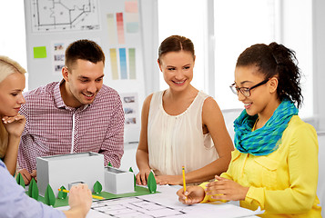 Image showing creative team with blueprint working at office