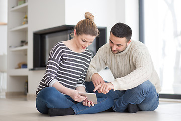 Image showing Young Couple using digital tablet on cold winter day