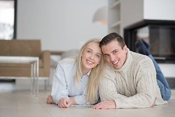 Image showing Young Couple using digital tablet on cold winter day