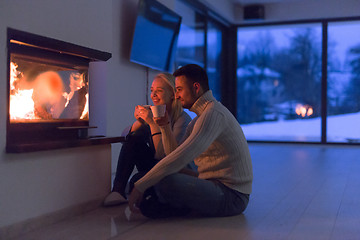 Image showing happy couple in front of fireplace