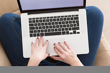 Image showing young woman on sofa at home websurfing