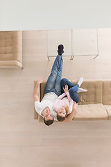 Image showing Young couple on the sofa watching television top view