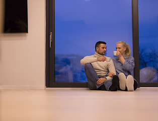 Image showing happy couple in front of fireplace