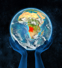 Image showing Angola on planet Earth in hands