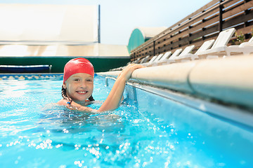 Image showing The portrait of happy smiling beautiful teen girl at the pool