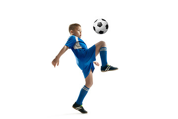 Image showing Young boy with soccer ball doing flying kick