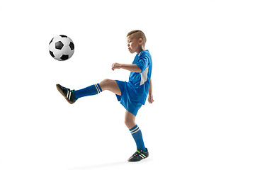 Image showing Young boy with soccer ball doing flying kick