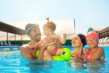 Image showing Happy family having fun by the swimming pool