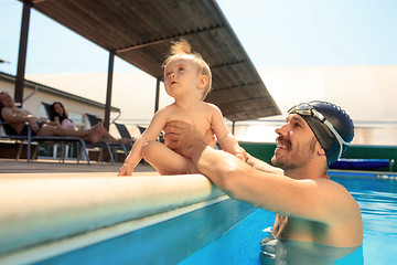 Image showing Happy family having fun by the swimming pool