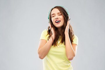 Image showing happy young woman or teenage girl with headphones