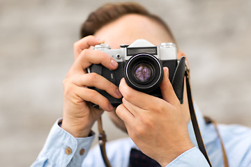 Image showing photographer with film camera making shot