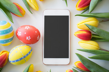 Image showing smartphone with easter eggs and tulip flowers