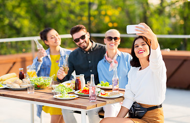 Image showing happy friends taking selfie at rooftop party