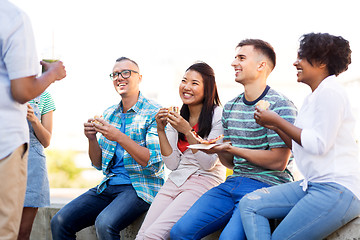 Image showing friends eating pizza and sandwiches in park