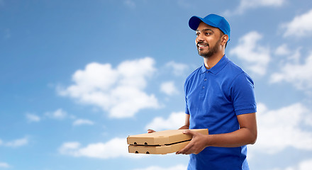 Image showing happy indian delivery man with pizza boxes in blue