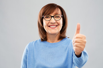 Image showing portrait of senior woman showing thumbs up