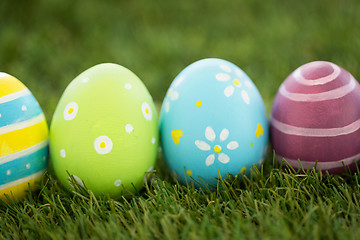 Image showing row of colored easter eggs on artificial grass