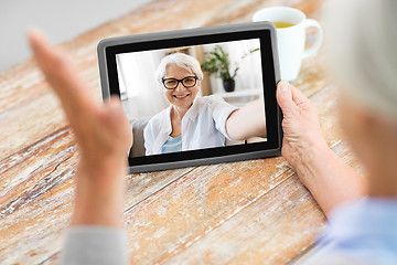 Image showing senior woman having video call on tablet computer