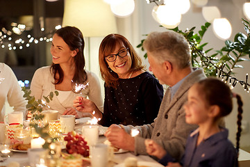 Image showing family with sparklers having tea party at home
