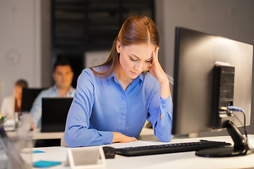 Image showing businesswoman with computer at night office