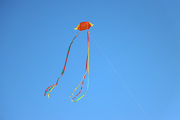 Image showing Colorful kite flying and blue sky as background