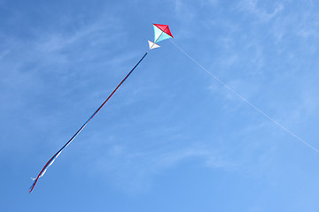 Image showing Colorful kite flying and blue sky as background
