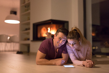 Image showing Young Couple using digital tablet on cold winter night