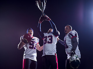 Image showing american football team with trophy celebrating victory