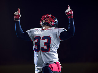 Image showing american football player celebrating after scoring a touchdown