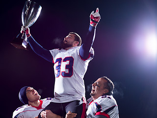 Image showing american football team with trophy celebrating victory