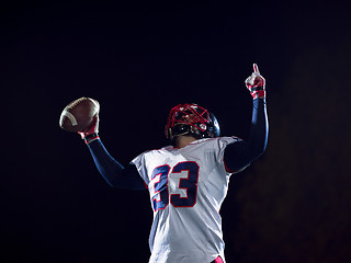 Image showing american football player celebrating after scoring a touchdown