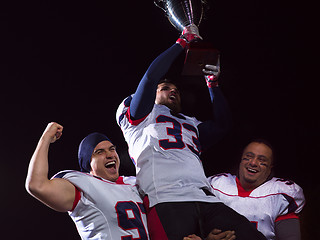 Image showing american football team with trophy celebrating victory