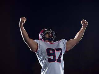 Image showing american football player celebrating after scoring a touchdown