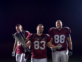 Image showing american football team with trophy celebrating victory