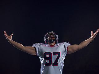 Image showing american football player celebrating after scoring a touchdown