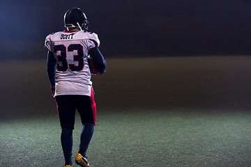 Image showing rear view of young confident American football player