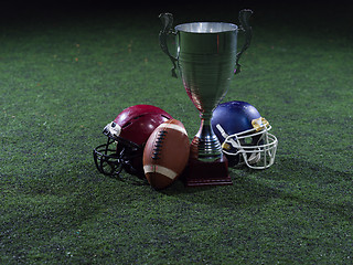 Image showing closeup of american football,helmets and trophy