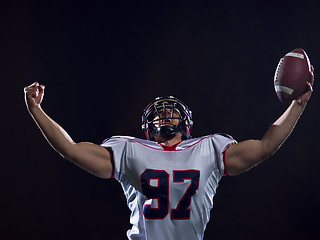 Image showing american football player celebrating after scoring a touchdown