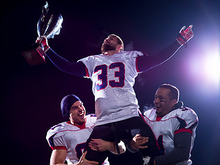 Image showing american football team with trophy celebrating victory