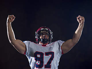 Image showing american football player celebrating after scoring a touchdown