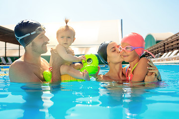 Image showing Happy family having fun by the swimming pool