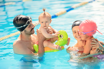 Image showing Happy family having fun by the swimming pool