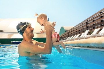 Image showing Happy family having fun by the swimming pool