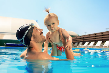 Image showing Happy family having fun by the swimming pool