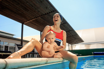 Image showing Happy family having fun by the swimming pool